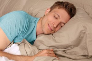 man blue shirt peaceful sleep